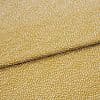 Mustard-yellow fabric with dense small white dot clusters; folded once across the center and lying flat as a close-up textile sample under neutral studio lighting.