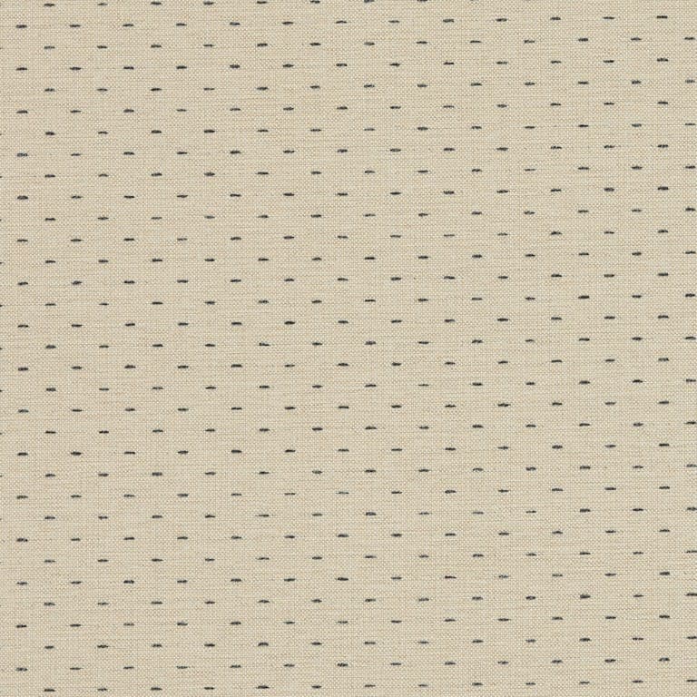 Beige woven fabric patterned with evenly spaced short navy-blue stitch dashes; close-up view showing textured weave and a subtle vertical seam, likely upholstery or curtain material in neutral indoor lighting.