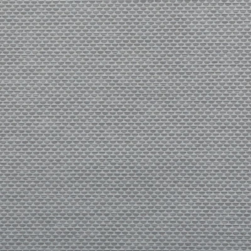 A grey woven roller blind covers the frame, closed and filtering light; tight horizontal weave forming small repeating diamond shapes, likely in an interior window setting with soft diffuse light.