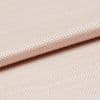 Light peach woven fabric with tight basket weave, folded in a shallow overlap; soft sheen catches diffused studio light, close-up view emphasizing texture and gentle drape.