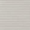 A closed light-gray pleated cellular blind with subtle linen texture, filtering and diffusing light evenly, covering a window within a neutral, softly lit interior.