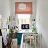 Pink fabric Roman blind, folded and lowered above a white roller blind, filtering soft daylight; compact bright home office with a desk, iMac clock, plants, pendant lamp, and wall art.
Transcription:
blah blah blah
1 07
PM
Le petit sac en papier