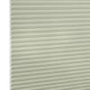Cellular honeycomb blind, pale sage, fully lowered with visible hexagonal cells at left, blocking light; close-up product shot against a neutral white background with soft, even lighting.
