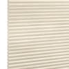 Beige honeycomb (cellular) blind, fully lowered with horizontal pleats and visible cells; closed and softly diffusing daylight; set against a neutral white-lit background with no visible room or view.