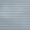 Horizontal pleated fabric blinds covering the entire window, closed in even light-blue-gray folds; filtering and diffusing daylight; interior setting with soft, uniform ambient lighting and no visible view.