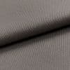 Gray woven fabric (canvas-like), folded diagonally over itself, showing dense pebble and twill textures; soft, even studio lighting highlights fine weave in a close-up, neutral setting.
