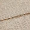 Beige textured fabric with raised, irregular wavy stripes—folded once across the middle—close-up view of a textile sample under soft, neutral studio lighting.