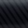 Venetian blind slats casting diagonal dark stripes across a textured black surface, filtering soft light in a dim, close-up scene with subtle grain and low contrast.