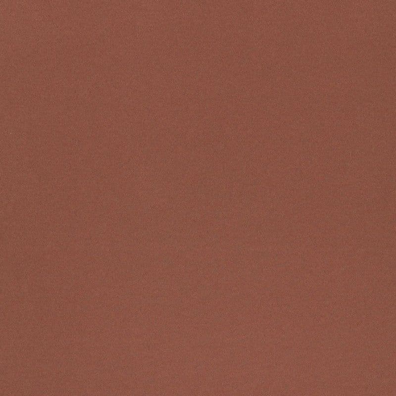 Rust-colored diagonal herringbone fabric occupying the frame, displaying fine woven texture and subtle diagonal striping; close-up, evenly lit surface with no visible objects or room context.