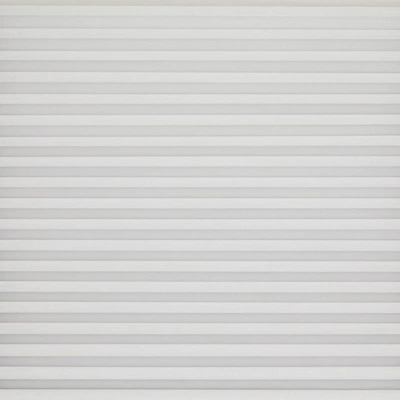 White horizontal pleated blinds covering the entire window, narrow evenly spaced slats; closed and softly diffusing daylight; set against a neutral wall in a bright, minimal interior.
