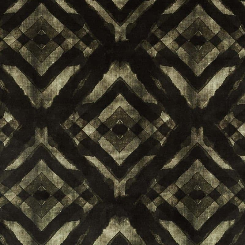 Dark textile with repeating diamond-and-chevron motif, watercolor-like black and olive strokes forming mirrored geometric shapes; displayed flat under even lighting, close-up view with no visible surroundings.