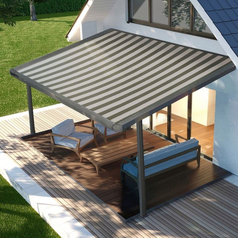 Striped gray-and-green fabric retractable awning, mounted to the house and supported by metal posts, fully extended and filtering sunlight over a wooden deck with lounge chairs beside glass doors.