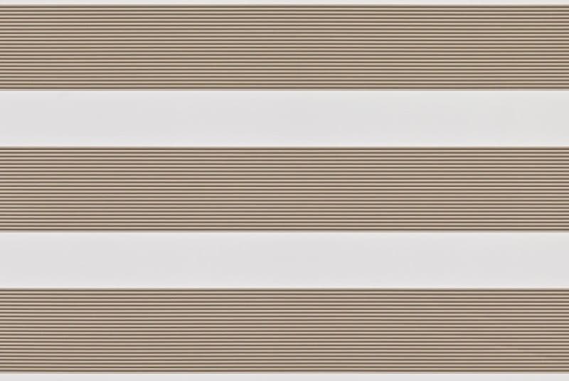 Dual-layer zebra roller blind lowered, alternating beige textured slats and white sheer bands; partially filtering light across a neutral interior wall, producing soft, evenly diffused daylight.