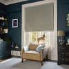 Patterned Roman blind with diamond motif, drawn almost fully down leaving a small gap; it filters soft daylight. Context: cozy teal living room, armchair by window with a small dog on the cushion.
OXFORD UNIVERSITY SHIRTS