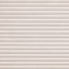 Beige textured pleated cellular blind, fully lowered and closed with horizontal folds; filtering soft, diffused daylight and obscuring the outside in a neutral interior setting.