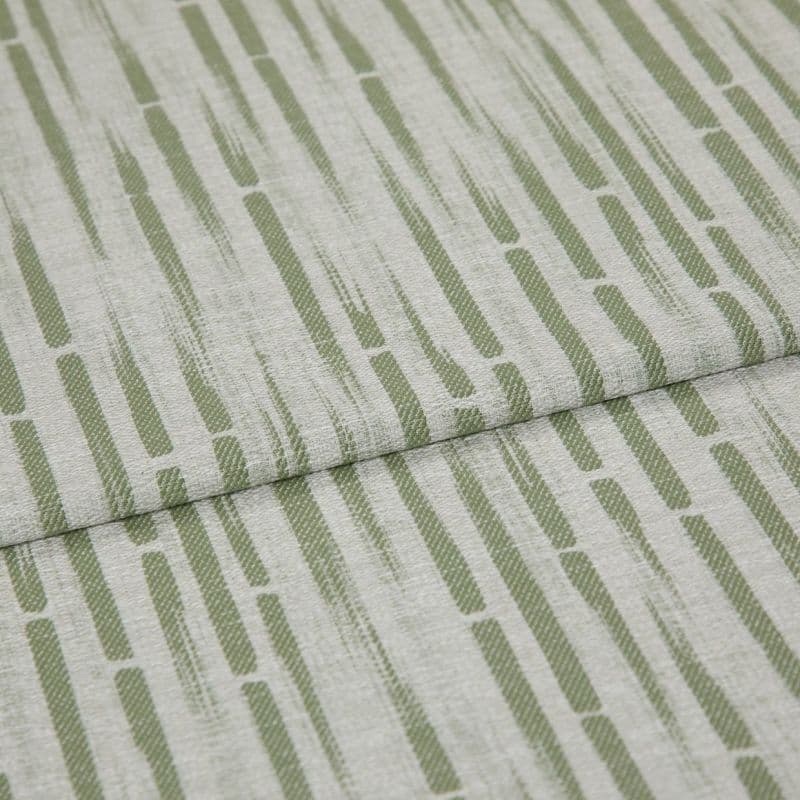 Textured upholstery fabric with vertical olive-green dashed stripes, folded once across the center creating an overlapping seam; close-up view with soft, even lighting and neutral, fabric-only background.