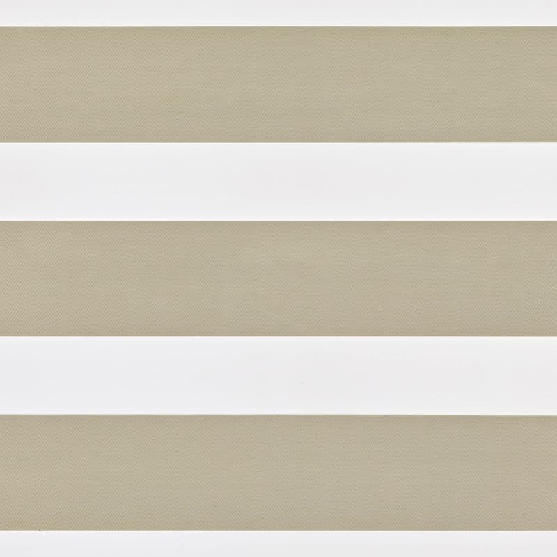 Zebra-style roller blind with alternating opaque white and semi-sheer beige herringbone-pattern bands, aligned horizontally and overlapping to partially filter light, set against a neutral-lit interior window area.