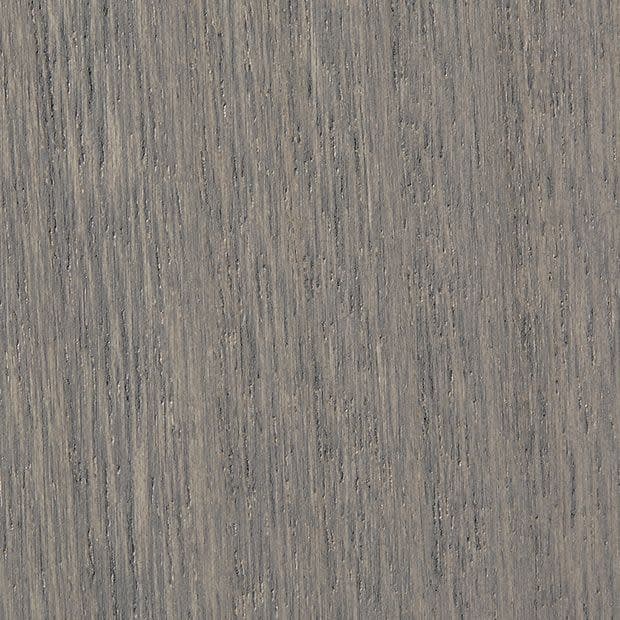 Gray-stained oak veneer with tight vertical grain and subtle knots, showing fine parallel striations and slight weathering, filling the frame as a studio-lit close-up sample.