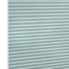 Honeycomb (cellular) shade, light-teal horizontal pleats, fully lowered; closed, softly diffusing light; close-up studio view against a white background.