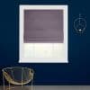 Mauve-gray fabric Roman shade lowered over a white-framed window, smoothing folds and filtering light; set against a deep navy wall with a gold circular sconce and gold wire chair.