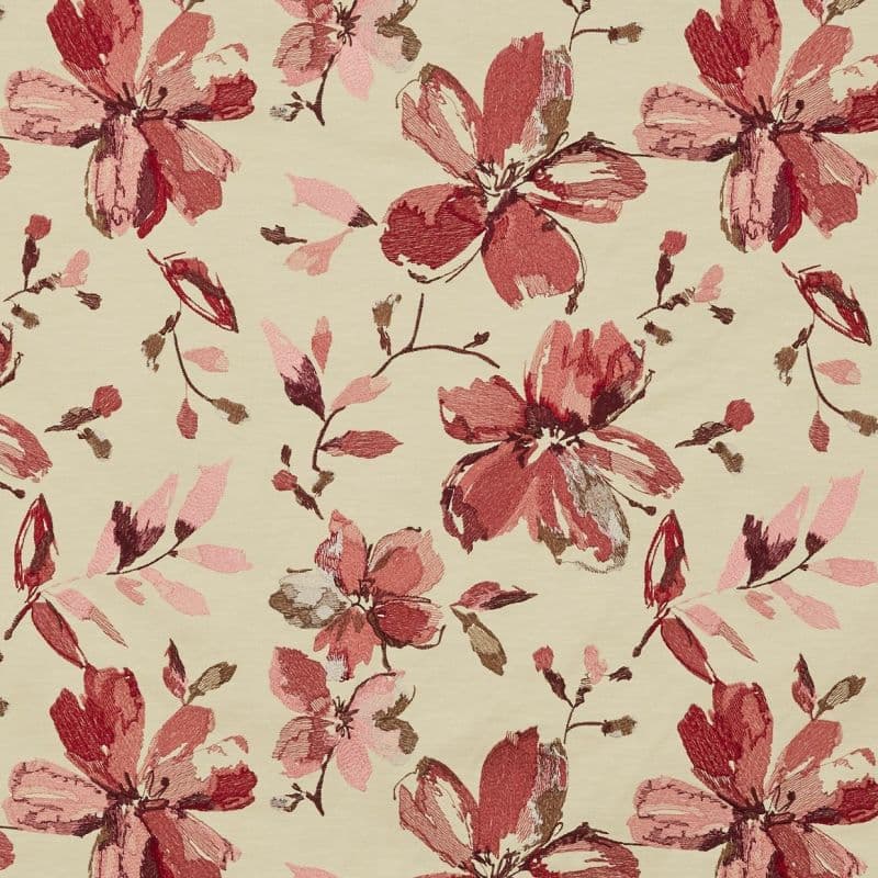 Beige fabric with large sketchy red and pink floral motifs — repeating all-over pattern across the surface — flat-lit close-up showing textured, embroidered-like detail.