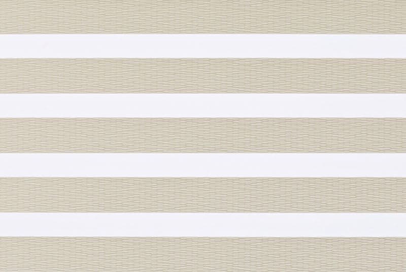 Layered horizontal-striped window blind (zebra style) across a window, alternating opaque white and beige woven sheer bands; closed in a neutral-lit interior, softly diffusing daylight.